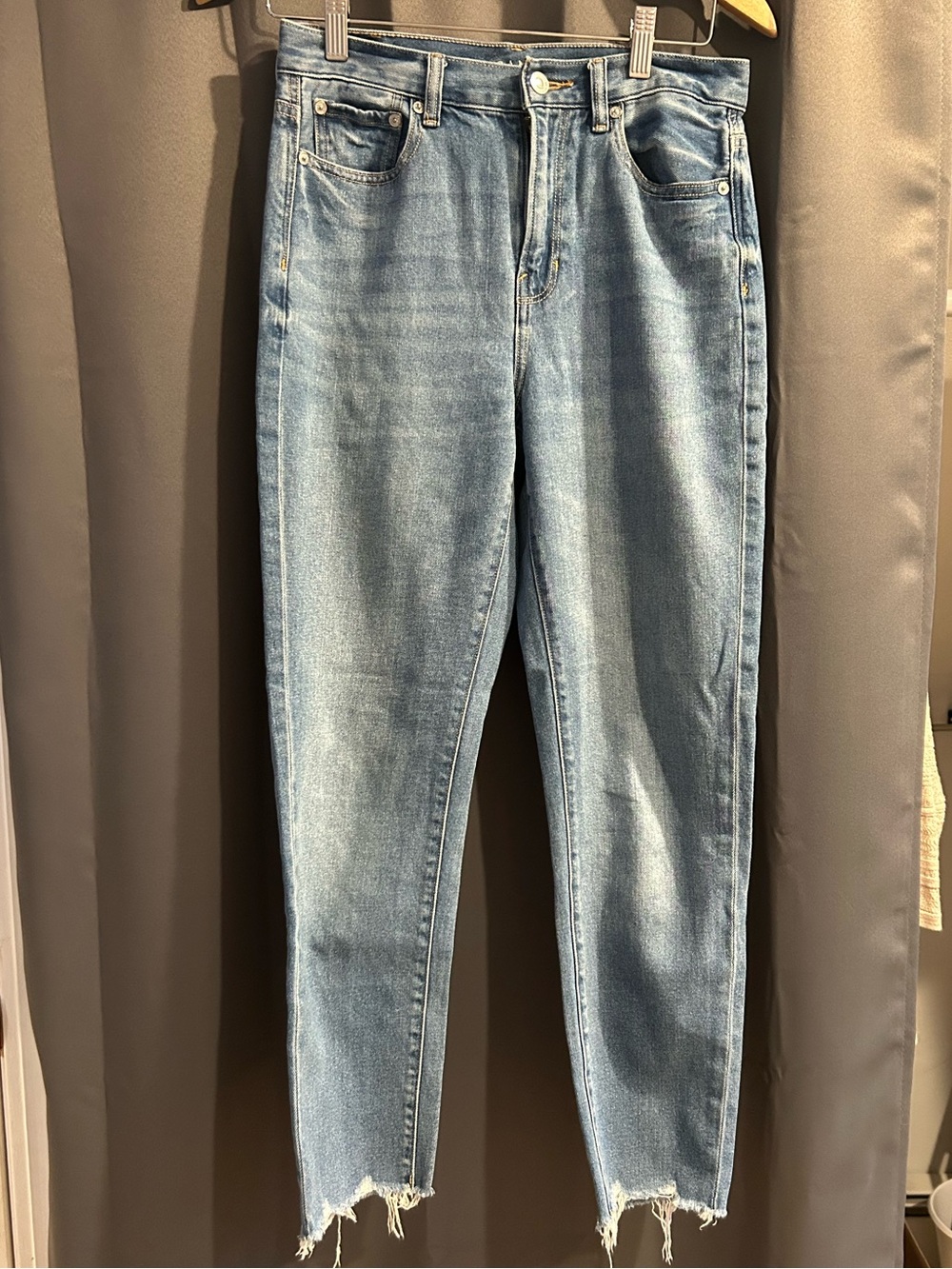 AE light wash high rise denim with distressed hem.  Size 4